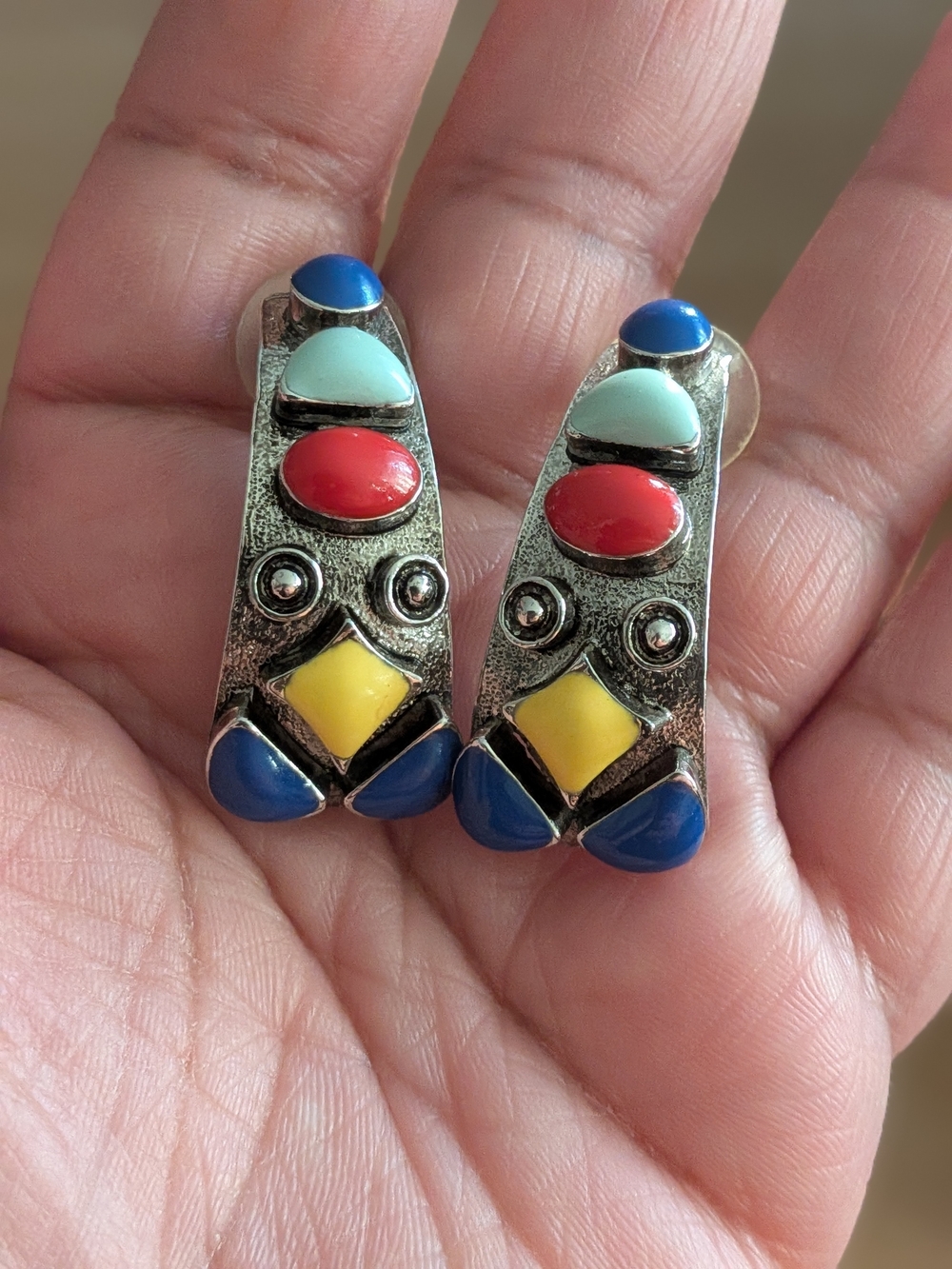 Southwest-style, silver-tone pierced earrings feature a multi-stone inlay design